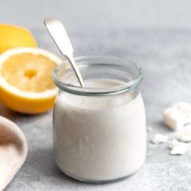 creamy feta yogurt dressing in a jar with a spoon