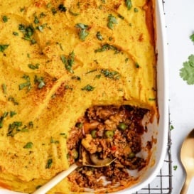 indian-inspired shepherd's pie in a baking dish with a spoon