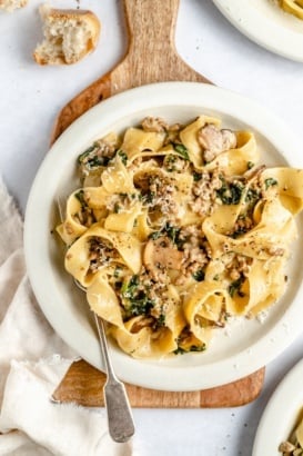 spinach beef pasta on a plate with a fork