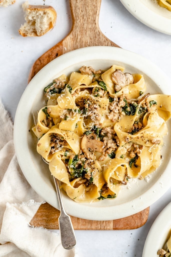 spinach beef pasta on a plate with a fork