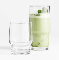 one short drinking glass next to one tall drinking glass