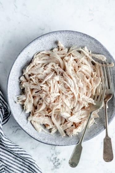 shredded chicken in a bowl with two forks