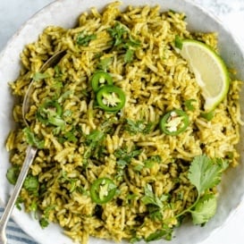 green rice in a bowl with a spoon