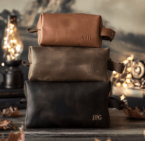 three leather dopp kits in a stack