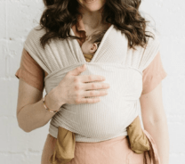 woman holding a baby in a wrap