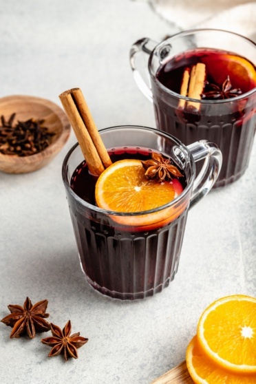 homemade mulled wine in a glass with an orange slice and cinnamon stick