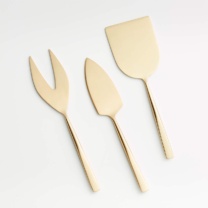three gold cheese knives