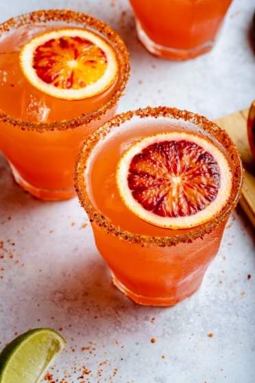 two blood orange margaritas in glasses