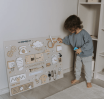 child playing with an activity board