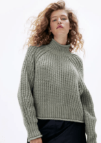 woman in a green sweater
