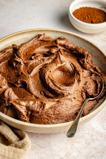 chocolate buttercream frosting in a bowl with a spoon