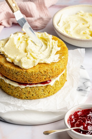 frosting a cake with lemon buttercream