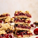 cherry pie bars stacked on a plate