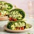 green goddess chicken salad wrap halves stacked on a plate
