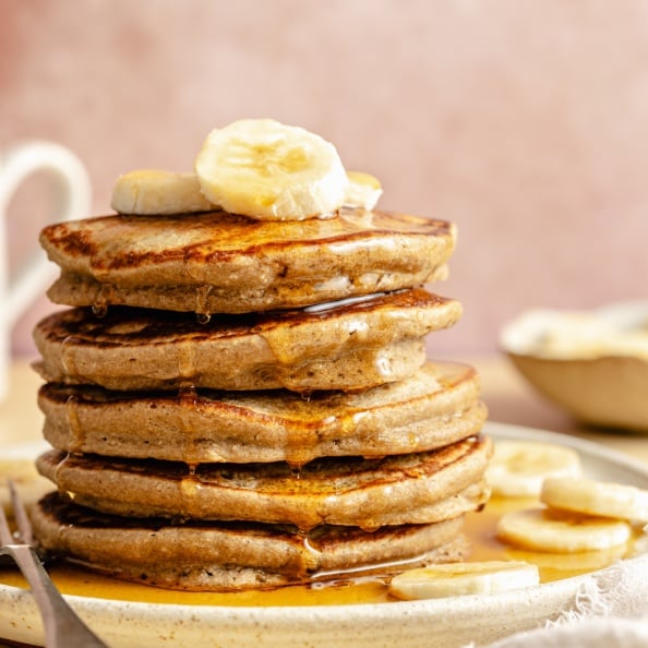 stack of banana oatmeal pancakes on a plate