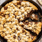 s'mores cookie skillet with a slice taken out