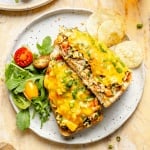 healthy chicken melt on a plate with a salad and chips