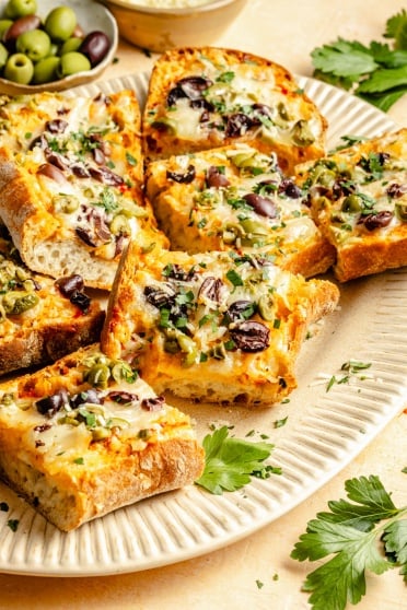 slices of olive cheese bread on a plate