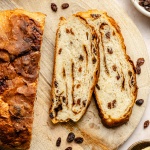 cinnamon raisin artisan bread sliced on a cutting board