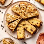 orange coffee cake with chocolate chips sliced on a plate