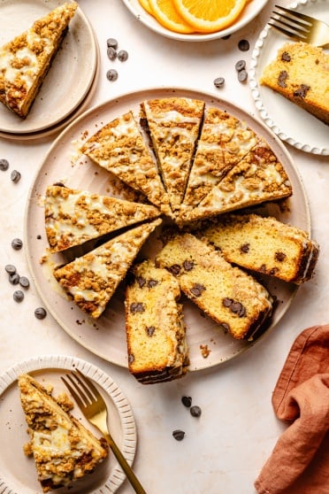 orange coffee cake with chocolate chips sliced on a plate