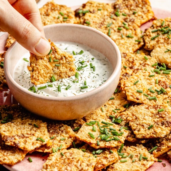 dipping a ranch cracker in a homemade ranch dip
