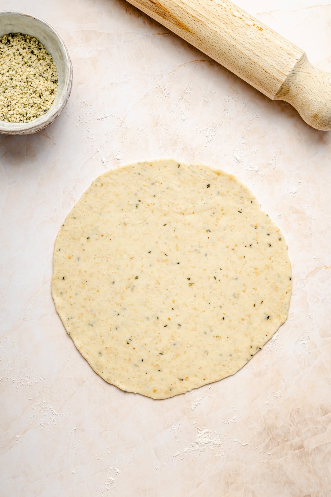uncooked homemade tortilla rolled out on a surface