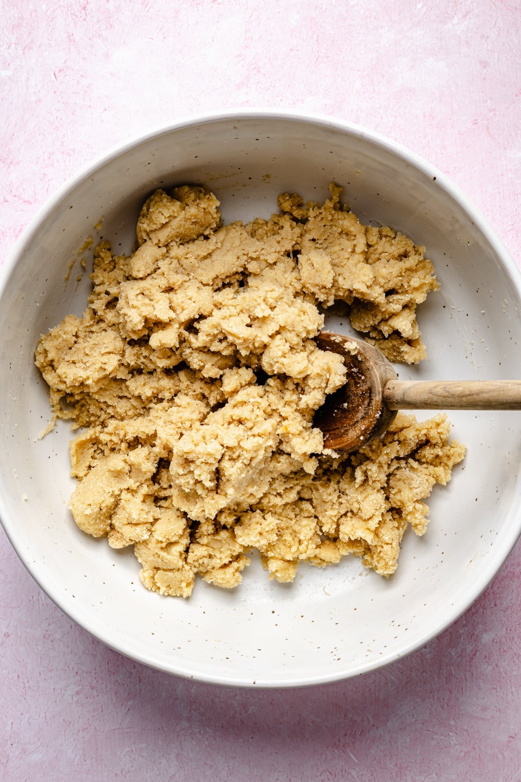 Soft, healthy banana cookies made with a mix of almond and coconut flour to make them gluten and grain-free! These banana bread cookies taste like a slice of your favorite banana bread and are topped with a luscious cream cheese frosting for a delicious treat everyone loves. healthy banana cookie dough in a bowl