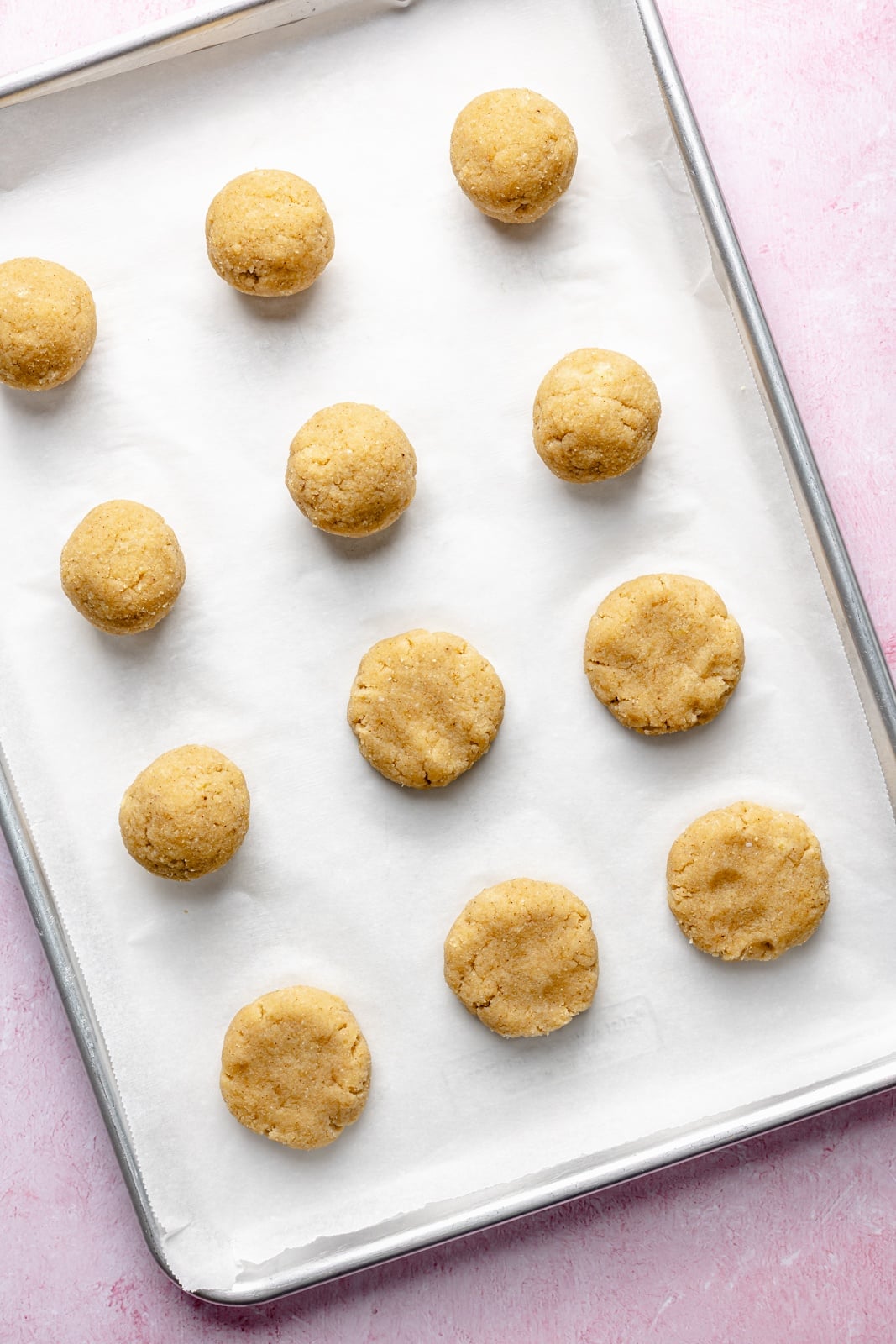 Soft, healthy banana cookies made with a mix of almond and coconut flour to make them gluten and grain-free! These banana bread cookies taste like a slice of your favorite banana bread and are topped with a luscious cream cheese frosting for a delicious treat everyone loves. unbaked gluten-free banana cookies on a baking sheet