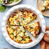 spinach and goat cheese quiche sliced in a pie dish