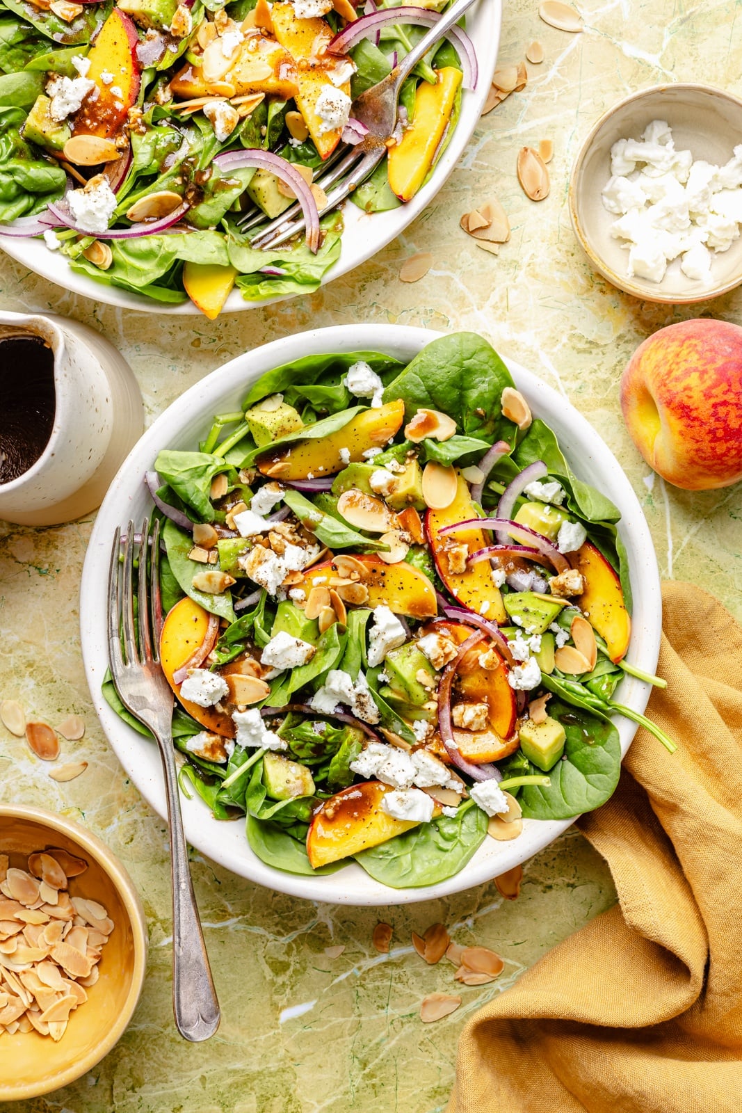 easy peach spinach salad in two bowls