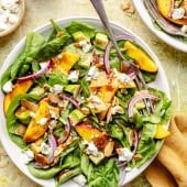 peach spinach salad in a bowl