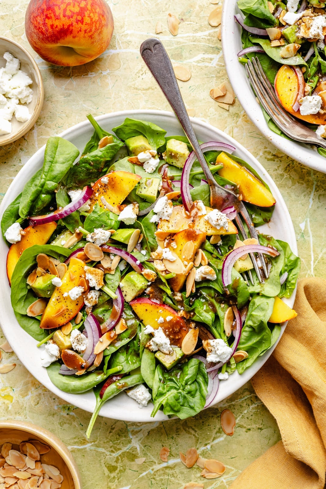 peach spinach salad in a bowl