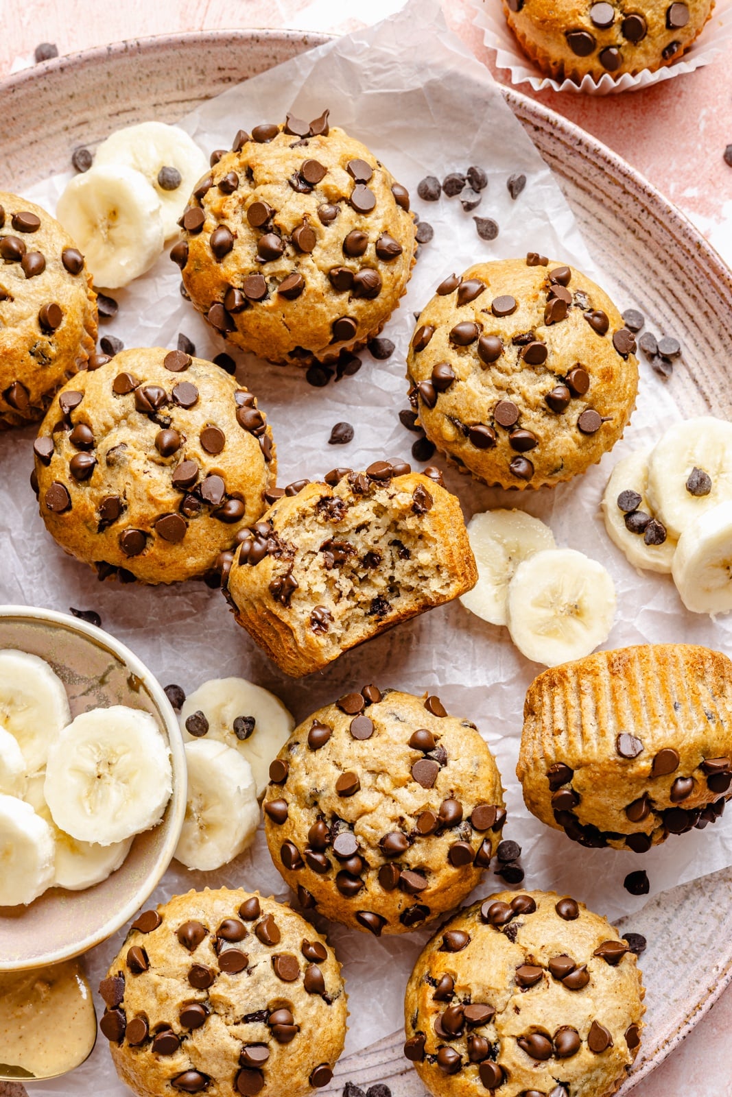 Healthy peanut butter banana muffins packed with protein and peanut butter flavor. These gluten-free peanut butter banana muffins are naturally sweetened with pure maple syrup, dairy-free, and a great on-the-go healthy breakfast or snack. Try them with mini chocolate chips! healthy peanut butter banana muffins on a tray
