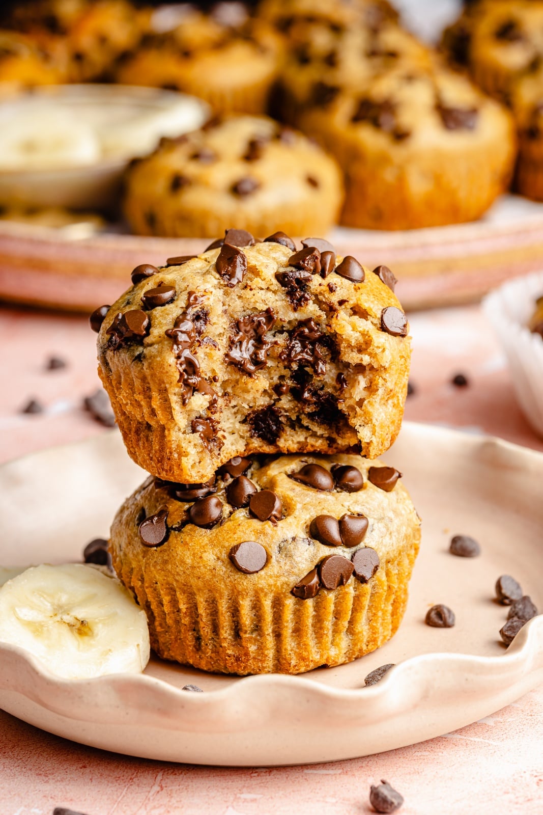 Healthy peanut butter banana muffins packed with protein and peanut butter flavor. These gluten-free peanut butter banana muffins are naturally sweetened with pure maple syrup, dairy-free, and a great on-the-go healthy breakfast or snack. Try them with mini chocolate chips! two peanut butter banana muffins in a stack