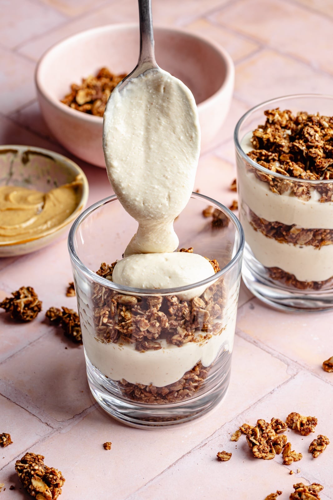 Creamy, high-protein peanut butter cup cheesecake jars layered with crunchy chocolate granola. Top these jars with fresh berries for a healthy breakfast or snack, and add chopped peanut butter cups for a more indulgent dessert! They take just 15 minutes to make and pack over 20g of protein from cottage cheese and greek yogurt. layering healthy peanut butter cup cheesecake jars