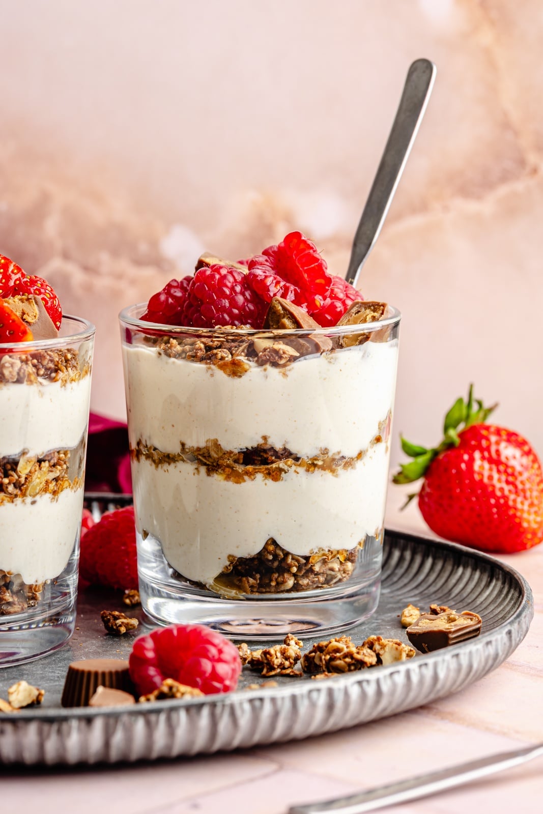 Creamy, high-protein peanut butter cup cheesecake jars layered with crunchy chocolate granola. Top these jars with fresh berries for a healthy breakfast or snack, and add chopped peanut butter cups for a more indulgent dessert! They take just 15 minutes to make and pack over 20g of protein from cottage cheese and greek yogurt. high-protein chocolate peanut butter cheesecake jars topped with berries