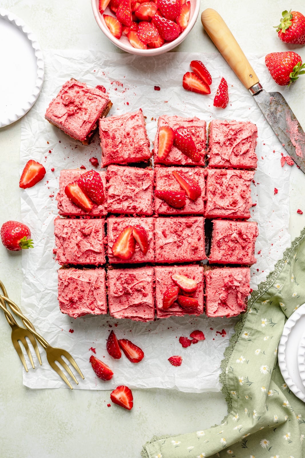 strawberry snacking cake sliced on parchment paper