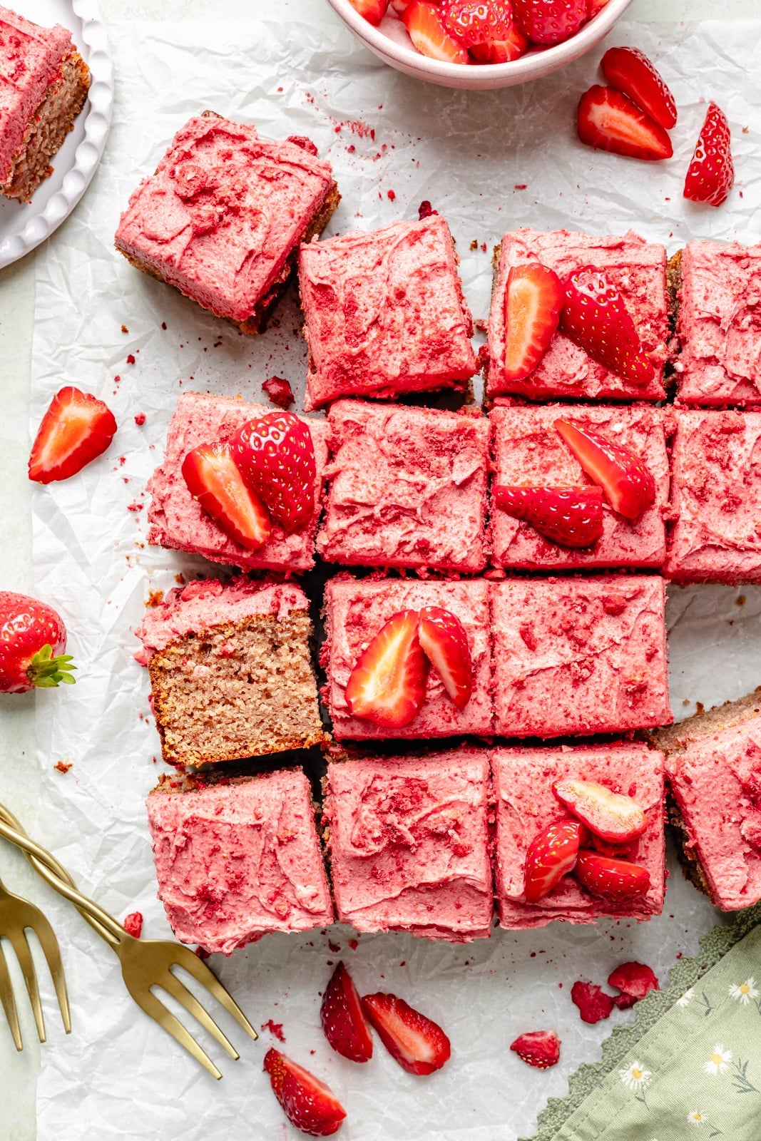 gluten-free strawberry snacking cake sliced on parchment paper
