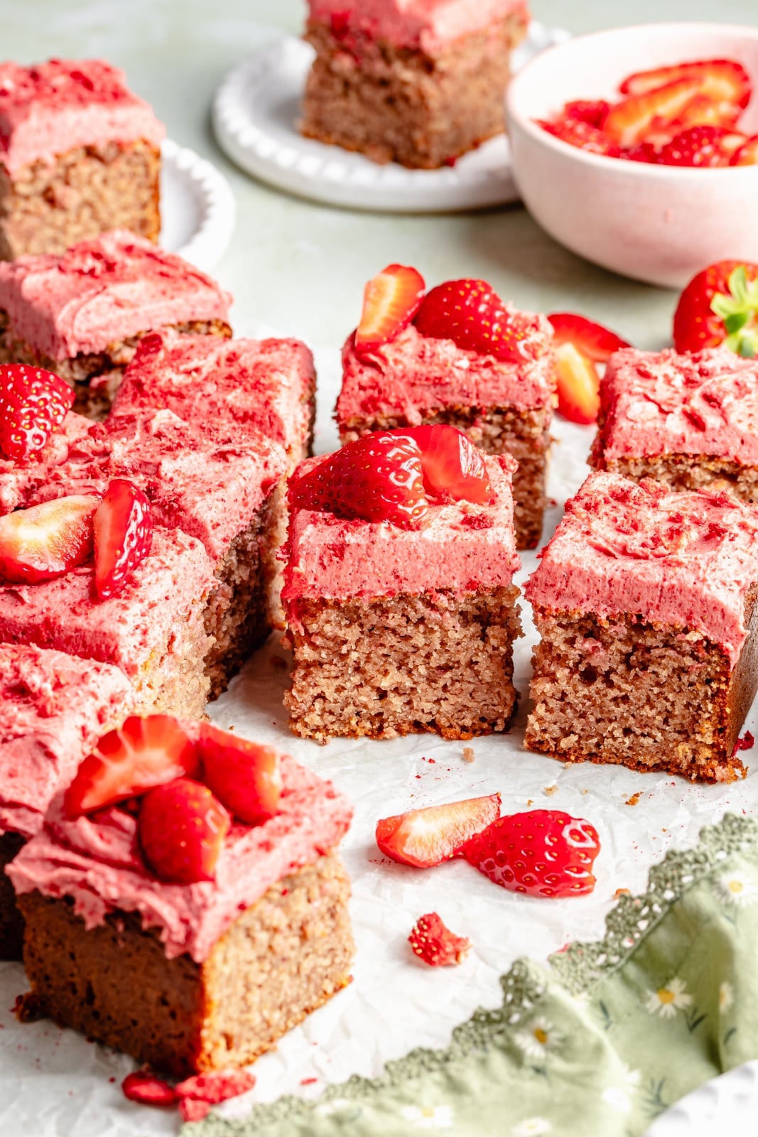 strawberry snacking cake topped with strawberry frosting