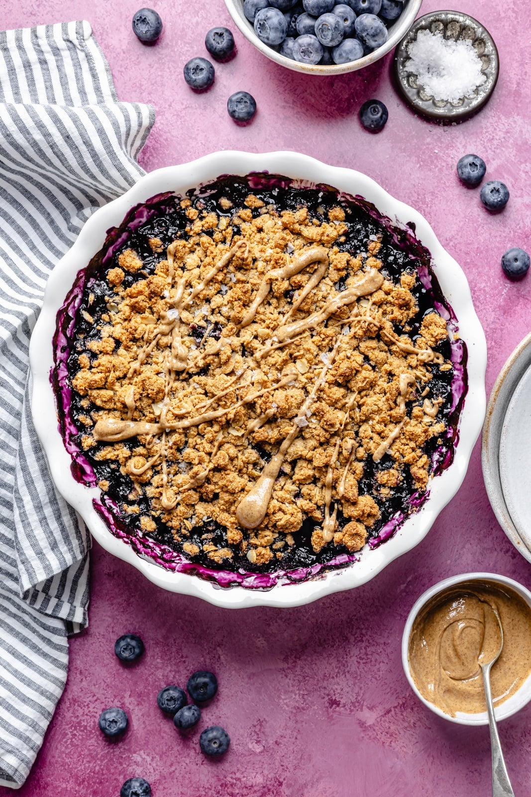 Golden, bubbly blueberry crisp with a perfectly sweet almond butter crumble. This delicious blueberry crisp recipe is easily made gluten-free, dairy-free, and vegan, and makes the perfect summer dessert for sharing. Add a scoop of vanilla ice cream and a drizzle of extra almond butter for good measure! the best blueberry crisp in a baking pan