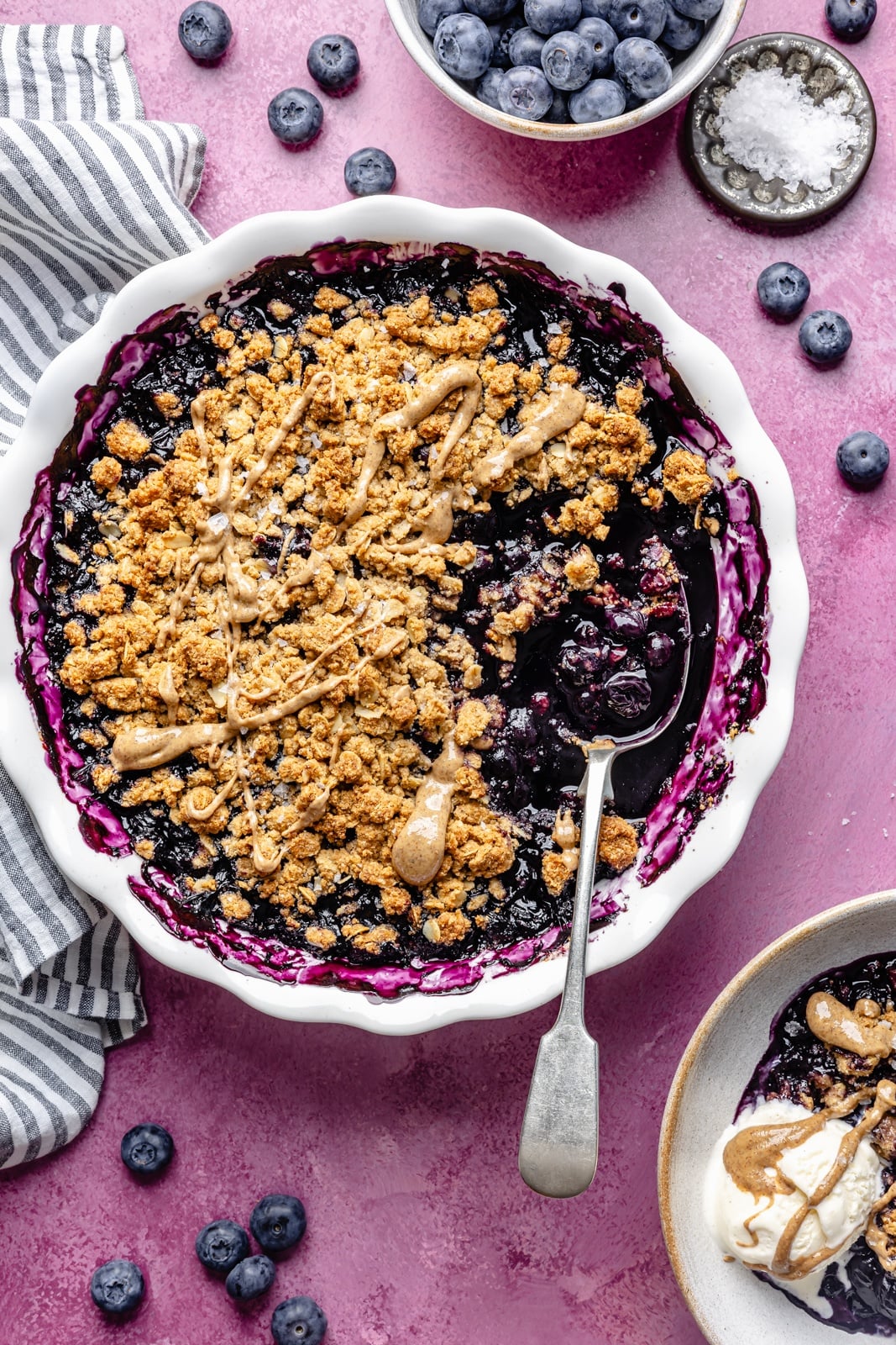 Golden, bubbly blueberry crisp with a perfectly sweet almond butter crumble. This delicious blueberry crisp recipe is easily made gluten-free, dairy-free, and vegan, and makes the perfect summer dessert for sharing. Add a scoop of vanilla ice cream and a drizzle of extra almond butter for good measure! healthy blueberry crisp in a baking dish