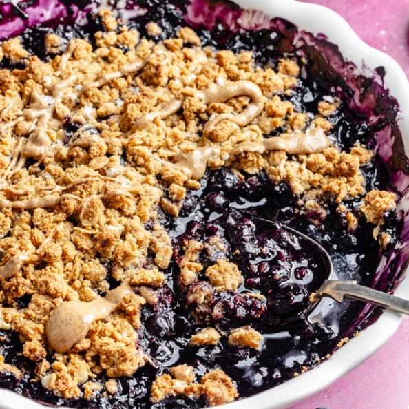 blueberry crisp with almond butter crumble in a baking dish