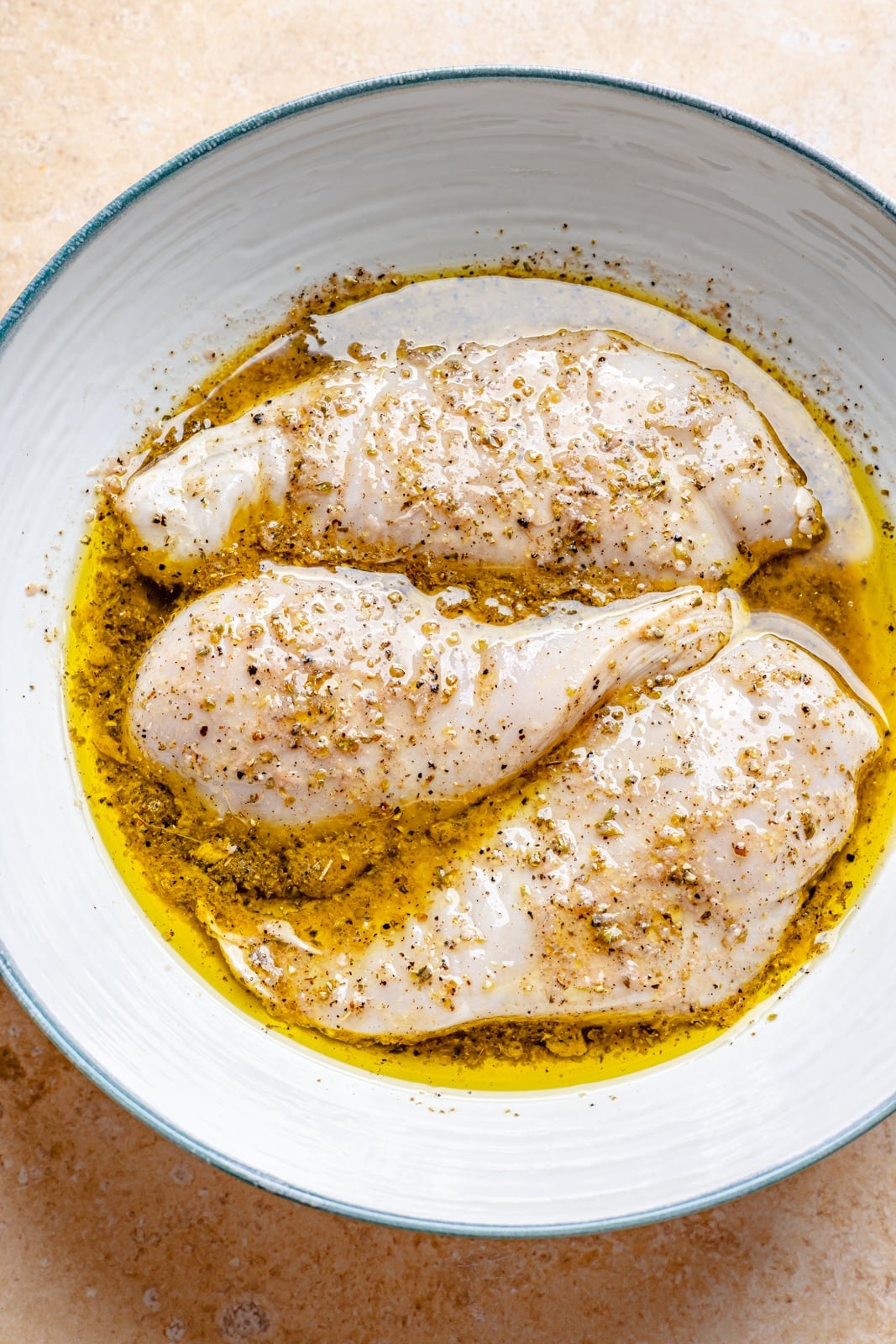 marinating chicken for a chimichurri pasta salad