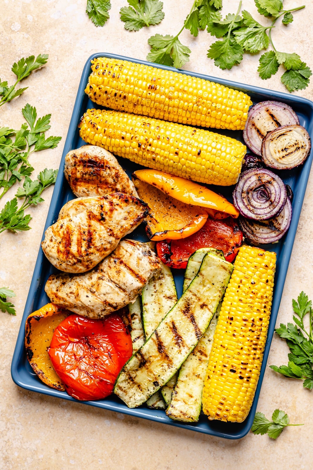 grilled vegetables and chicken on a platter to make chimichurri pasta salad