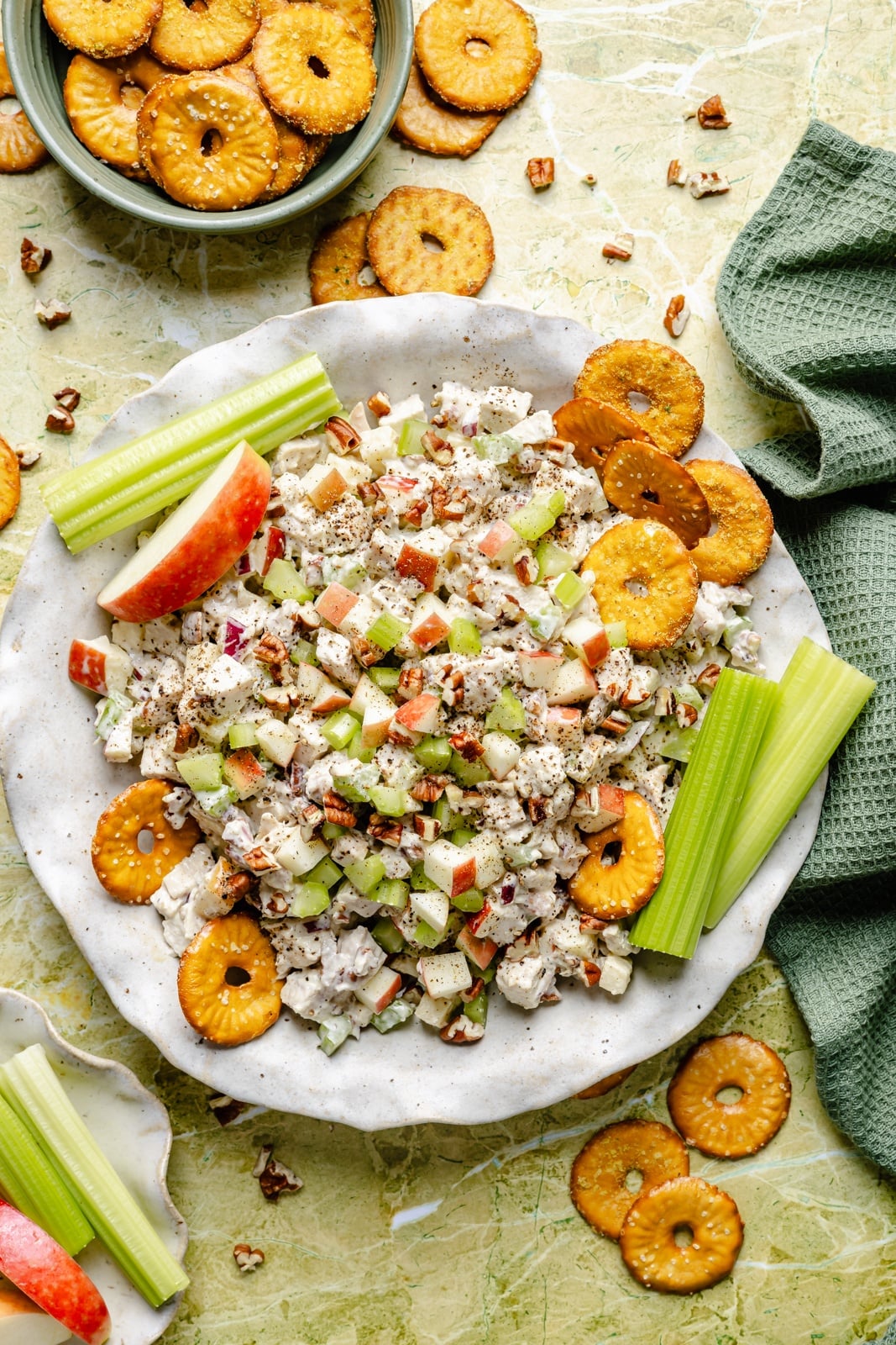 Fresh, high-protein honey mustard chicken salad mixed with a flavorful Greek yogurt-based dressing, juicy honeycrisp apples, and plenty of crunch from celery and nuts. Scoop it with crackers or enjoy it as a sandwich or wrap for the perfect no cook lunch that's ready in 15 minutes! easy honey mustard chicken salad in a bowl with celery and pretzels