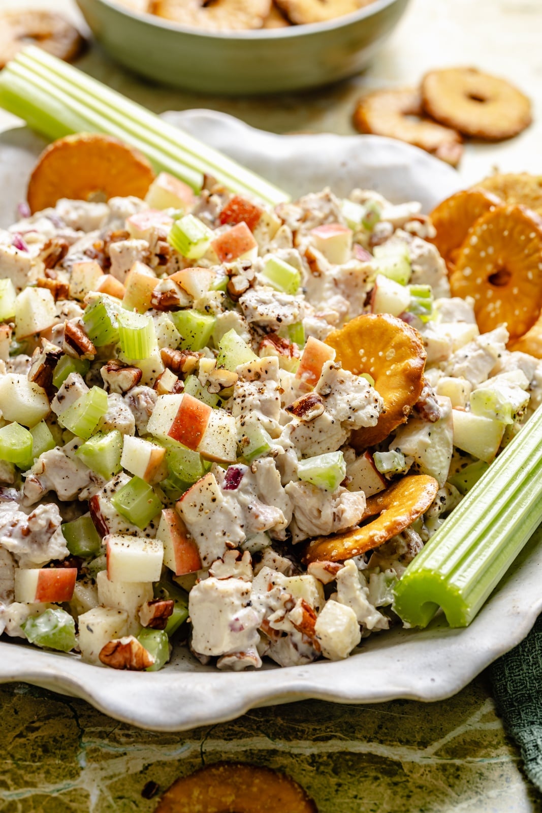 Fresh, high-protein honey mustard chicken salad mixed with a flavorful Greek yogurt-based dressing, juicy honeycrisp apples, and plenty of crunch from celery and nuts. Scoop it with crackers or enjoy it as a sandwich or wrap for the perfect no cook lunch that's ready in 15 minutes! high-protein honey mustard chicken salad with apples and celery in a bowl