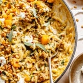 brown butter sage orzo with butternut squash and sausage in a pan with a spoon