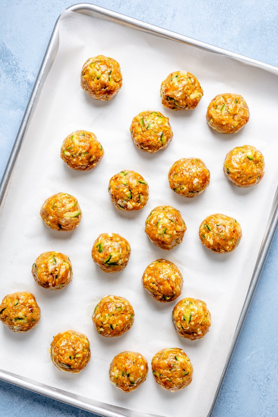 unbaked chicken shawarma meatballs on a baking sheet