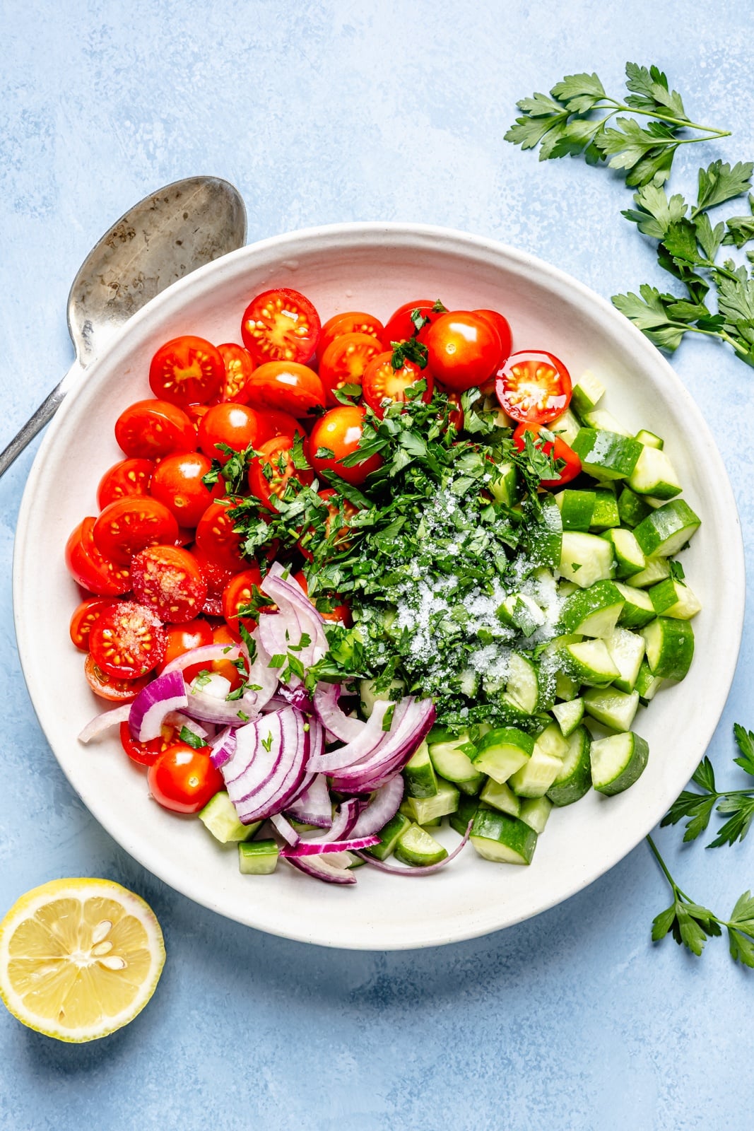 ingredients for a salad for chicken shawarma meatballs bowls in a mixing bowl